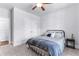 Bedroom with neutral walls and carpet, a bed with patterned bedding, and a ceiling fan for added comfort at 510 Cunninghame Ct, Peachtree City, GA 30269