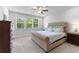 Comfortable bedroom with a plush bed, soft carpet, and a large window for natural light at 510 Cunninghame Ct, Peachtree City, GA 30269