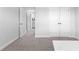 Bedroom with gray carpet and white trim looking toward hallway and closet doors at 510 Cunninghame Ct, Peachtree City, GA 30269