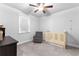 Bedroom featuring a crib, comfortable chair, and neutral tones at 510 Cunninghame Ct, Peachtree City, GA 30269