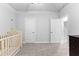 Bedroom featuring a crib, white walls, and carpet at 510 Cunninghame Ct, Peachtree City, GA 30269