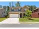 Charming two-story home featuring a brick and gray facade, manicured lawn, and a two-car garage at 510 Cunninghame Ct, Peachtree City, GA 30269