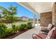 Inviting covered front porch with cozy seating, offering a serene view of the neighborhood street at 510 Cunninghame Ct, Peachtree City, GA 30269