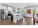 Spacious kitchen with stainless appliances, white cabinets, gray backsplash, and an island with bar stool seating at 510 Cunninghame Ct, Peachtree City, GA 30269