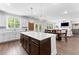 Open concept kitchen with stainless steel appliances, large island, and connection to the living and dining areas at 510 Cunninghame Ct, Peachtree City, GA 30269
