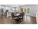 Bright, open kitchen features white cabinets, stainless steel appliances, a large island, and an adjacent dining area at 510 Cunninghame Ct, Peachtree City, GA 30269