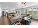 Open-concept living room with a fireplace, natural light, hardwood floors, and views into the kitchen at 510 Cunninghame Ct, Peachtree City, GA 30269