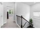 Upstairs landing with carpet, window, and spindled railing at 510 Cunninghame Ct, Peachtree City, GA 30269