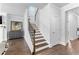 Elegant staircase with wood treads and iron spindles, leading to the upper level of the home at 510 Cunninghame Ct, Peachtree City, GA 30269