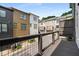View of a back porch featuring a row of townhomes and greenery in the background at 752 Winton Way, Atlanta, GA 30312
