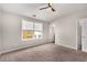 Bright bedroom features neutral walls, a ceiling fan, and a large window overlooking the exterior at 752 Winton Way, Atlanta, GA 30312