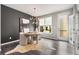 A stylish dining area features wood floors, modern light fixture, and a cowhide rug at 752 Winton Way, Atlanta, GA 30312