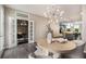 Open dining area with modern chandelier and view of modern kitchen, living area, and office nook with glass doors at 752 Winton Way, Atlanta, GA 30312