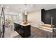 Modern kitchen island with stainless steel sink, quartz countertops, dark wood cabinetry and luxury vinyl plank flooring at 752 Winton Way, Atlanta, GA 30312