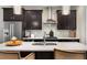 Close-up of kitchen island featuring stainless steel sink, modern faucet, quartz countertop, stainless appliances and dark cabinets at 752 Winton Way, Atlanta, GA 30312