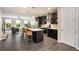 Modern kitchen featuring a central island, stainless steel appliances, and dark wood cabinetry with open concept view at 752 Winton Way, Atlanta, GA 30312