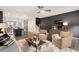 Cozy living room featuring hardwood floors, two plush chairs, modern fixtures and open plan view of stairs and kitchen at 752 Winton Way, Atlanta, GA 30312