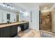 Bathroom showcasing a double vanity, shower, and tiled floor at 3005 Park Chase, Alpharetta, GA 30022