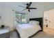Bright bedroom features a ceiling fan, plush carpet and a queen bed with a tufted headboard at 3005 Park Chase, Alpharetta, GA 30022