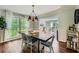 Inviting dining room with large windows, elegant light fixture, and hardwood floors at 3005 Park Chase, Alpharetta, GA 30022
