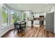 Bright eat-in kitchen features white cabinets, stainless steel appliances, and hardwood floors at 3005 Park Chase, Alpharetta, GA 30022