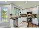 Modern kitchen with stainless steel appliances, granite countertops, and white cabinets at 3005 Park Chase, Alpharetta, GA 30022