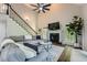 Well-lit living room with a fireplace, vaulted ceiling, and staircase at 3005 Park Chase, Alpharetta, GA 30022