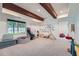 Bright playroom with exposed wood beams, large window, alphabet wall art, and cushioned seating at 3005 Park Chase, Alpharetta, GA 30022