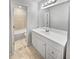 Bright bathroom featuring a white vanity with a large mirror and tiled floor at 3008 Pine Tree Trl # 16D, Atlanta, GA 30349