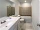 Bright bathroom featuring tiled shower and bathtub combination, toilet and white single sink vanity at 3008 Pine Tree Trl # 16D, Atlanta, GA 30349