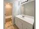 Bright bathroom featuring tiled shower and bathtub combination with single sink vanity at 3008 Pine Tree Trl # 16D, Atlanta, GA 30349