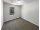 Bedroom with neutral carpeting, one window with view of trees, and white walls at 3008 Pine Tree Trl # 16D, Atlanta, GA 30349