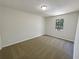 A cozy bedroom with neutral carpeting, white walls, and a view of trees through the window at 3008 Pine Tree Trl # 16D, Atlanta, GA 30349