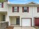 Charming townhome featuring an attached garage and red window shutters at 3008 Pine Tree Trl # 16D, Atlanta, GA 30349