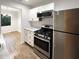 Modern kitchen featuring stainless steel appliances, white cabinetry, and hardwood floors at 3008 Pine Tree Trl # 16D, Atlanta, GA 30349