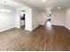 Open concept living area with hardwood floors seamlessly connects dining to kitchen at 3008 Pine Tree Trl # 16D, Atlanta, GA 30349