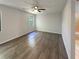Spacious main bedroom with hardwood floors, ceiling fan, and one window with backyard view at 3008 Pine Tree Trl # 16D, Atlanta, GA 30349