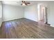 Spacious main bedroom featuring hardwood floors, ceiling fan, and ensuite bathroom at 3008 Pine Tree Trl # 16D, Atlanta, GA 30349