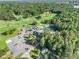 Aerial view showcasing the community's amenities with pool, tennis courts, clubhouse, and lush trees at 1156 Magnolia Dr, Villa Rica, GA 30180