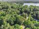 Aerial view of the neighborhood showcasing the treed landscape and nearby lake at 1156 Magnolia Dr, Villa Rica, GA 30180