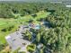 Wide aerial view of a community clubhouse featuring a pool, tennis courts, and golf course at 1156 Magnolia Dr, Villa Rica, GA 30180