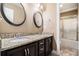 Bathroom featuring double sinks, granite counters, and a glass door shower at 1156 Magnolia Dr, Villa Rica, GA 30180