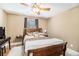 Cozy bedroom featuring hardwood floors, a ceiling fan, and a window at 1156 Magnolia Dr, Villa Rica, GA 30180