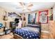 A cozy bedroom featuring hardwood floors, a ceiling fan, and a large bed with a blue star patterned comforter at 1156 Magnolia Dr, Villa Rica, GA 30180