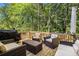 Outdoor deck space with cozy seating and grill perfect for entertaining and overlooking the lush backyard at 1156 Magnolia Dr, Villa Rica, GA 30180