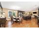 Bright, open dining area with hardwood floors, a view to the living room, and modern stainless steel appliances at 1156 Magnolia Dr, Villa Rica, GA 30180
