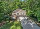 Inviting home with a well-maintained lawn, a two-car garage, and classic architectural details in a wooded area at 1156 Magnolia Dr, Villa Rica, GA 30180