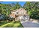 Charming two-story home with a well-manicured lawn and a two-car garage in a lush, wooded setting at 1156 Magnolia Dr, Villa Rica, GA 30180