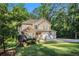 Attractive two-story home with a well-manicured lawn and a two-car garage nestled among trees at 1156 Magnolia Dr, Villa Rica, GA 30180