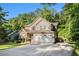 Attractive two-story home with a spacious driveway, lawn, and mature trees offering shade and curb appeal at 1156 Magnolia Dr, Villa Rica, GA 30180